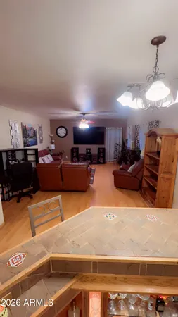 a living room with furniture a pool table and a fireplace