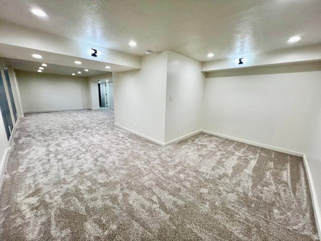 812 East Bates Cyn Road Tooele, UT 84074 - Photo 79 of 144 Spacious room featuring new carpeting, recessed lighting, white baseboards, and neutral wall finishes