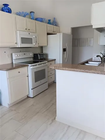 a kitchen with stainless steel appliances granite countertop cabinets and a refrigerator