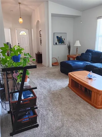 a spacious bedroom with a bed and a chandelier