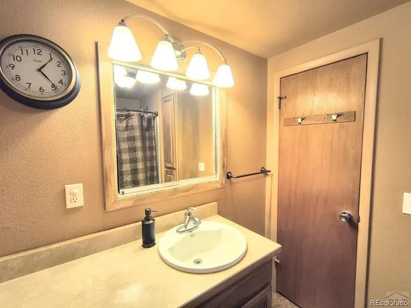 an empty room with a window and a ceiling fan