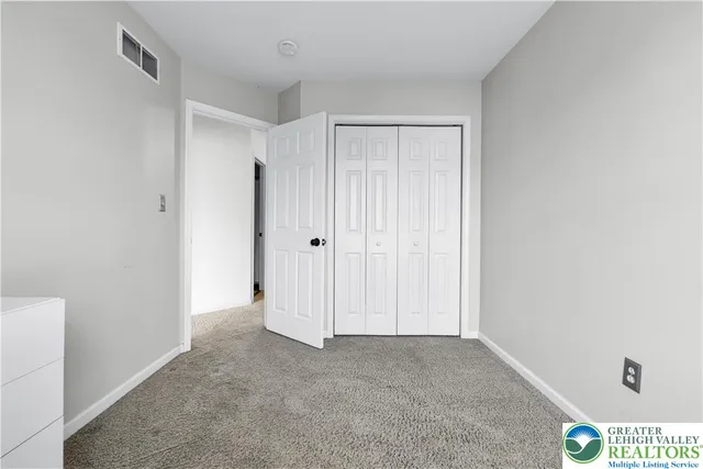 a view of a porch with furniture and floor to ceiling window