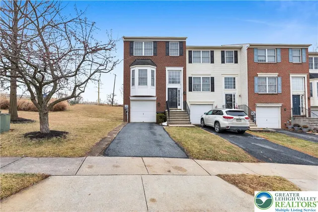 a living room with furniture a flat screen tv and a window