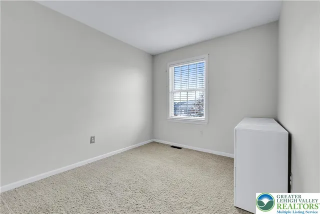a view of a patio with a table and chairs