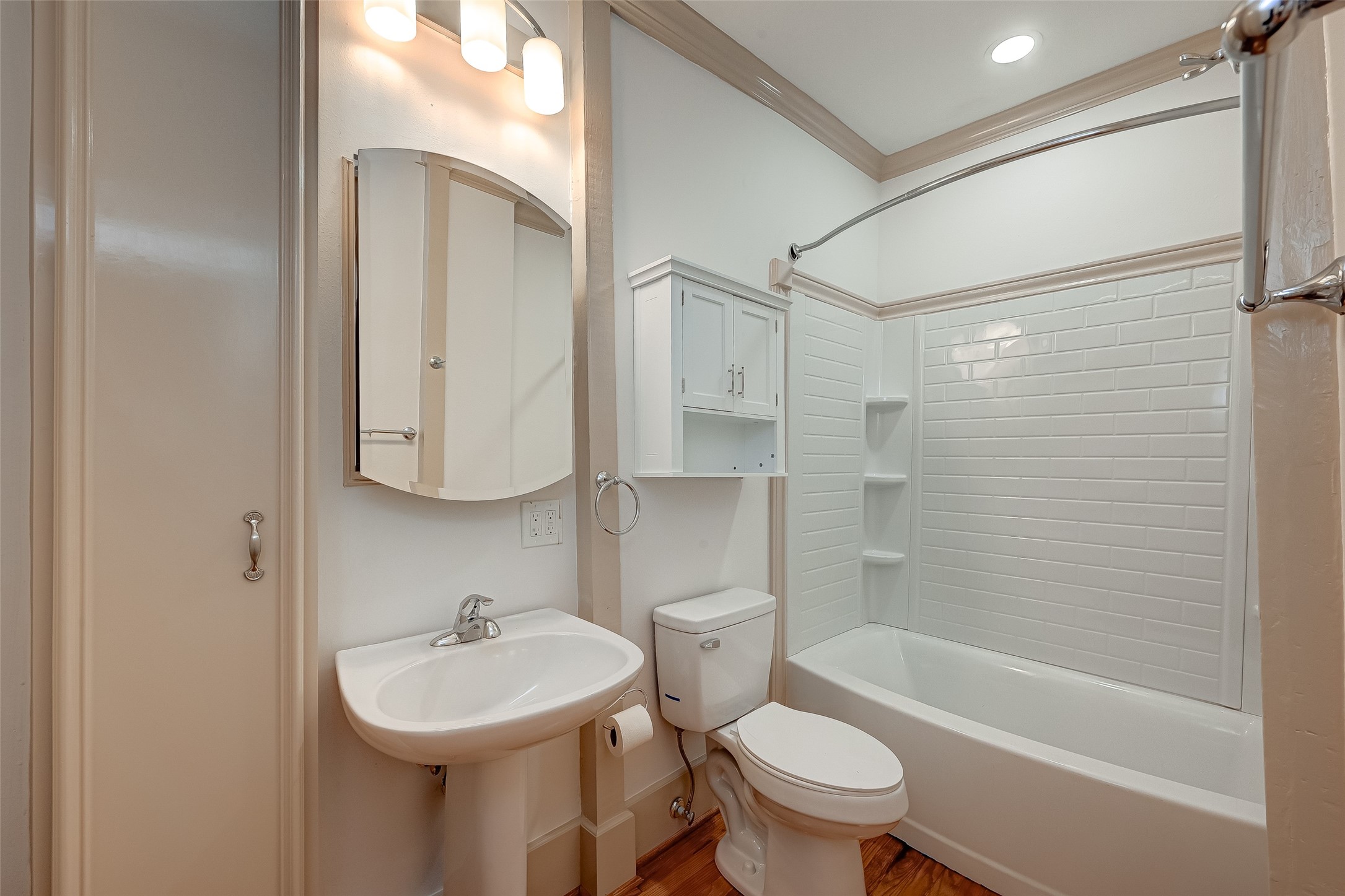 2009 State Street Houston, TX 77007 - Photo 27 of 42 is closer vision of the primary bedroom bath, note the inlay storage cabinet next to the medicine cabinet, along with wood accent with an additional vanity cabinet over the commode