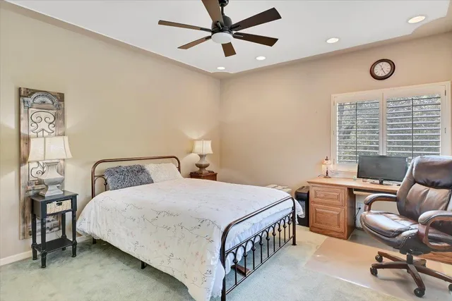 a bedroom with a large bed and a chandelier