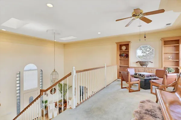 a bathroom with a granite countertop sink and a large mirror