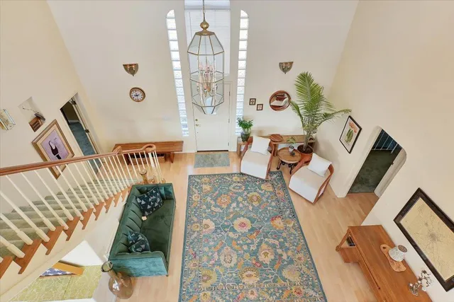 a view of staircase with railing and white walls