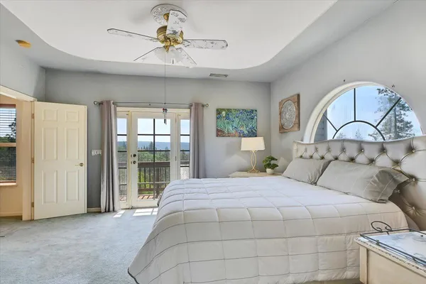 a large kitchen with granite countertop a sink white cabinets and stainless steel appliances