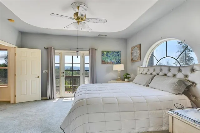 a large kitchen with granite countertop a sink white cabinets and stainless steel appliances