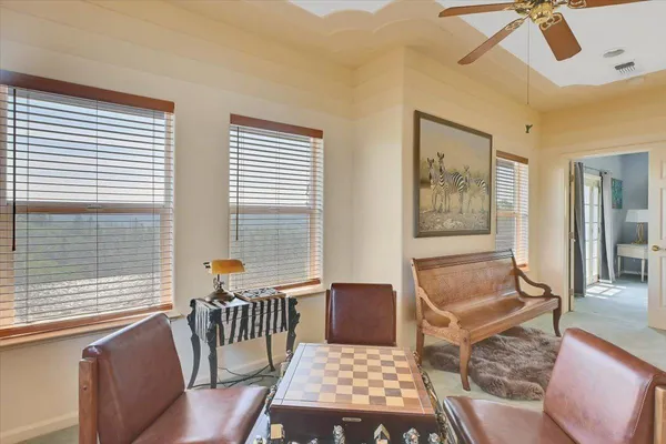 a view of a livingroom with furniture and a ceiling fan