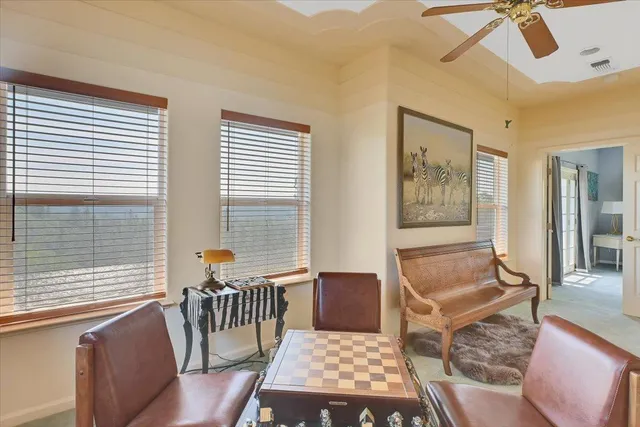 a view of a livingroom with furniture and a ceiling fan