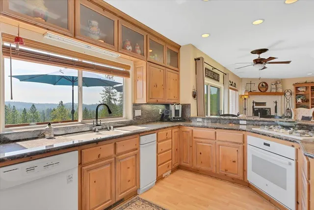 a view of a garden with a bench in front of house