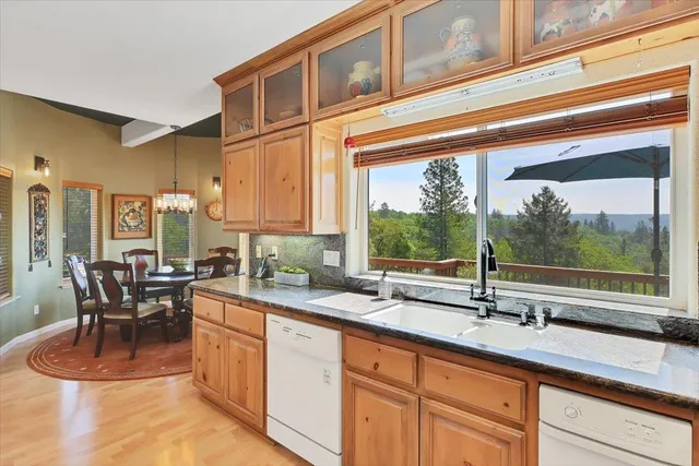 a aerial view of a house with swimming pool and next to a yard