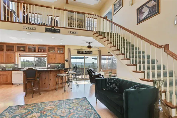 a living room with furniture a fireplace and a large window