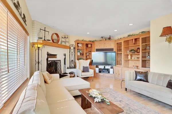 a bedroom with a bed a desk and chair with a bookshelf