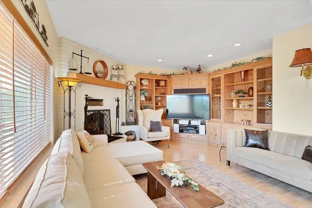 a bedroom with a bed a desk and chair with a bookshelf
