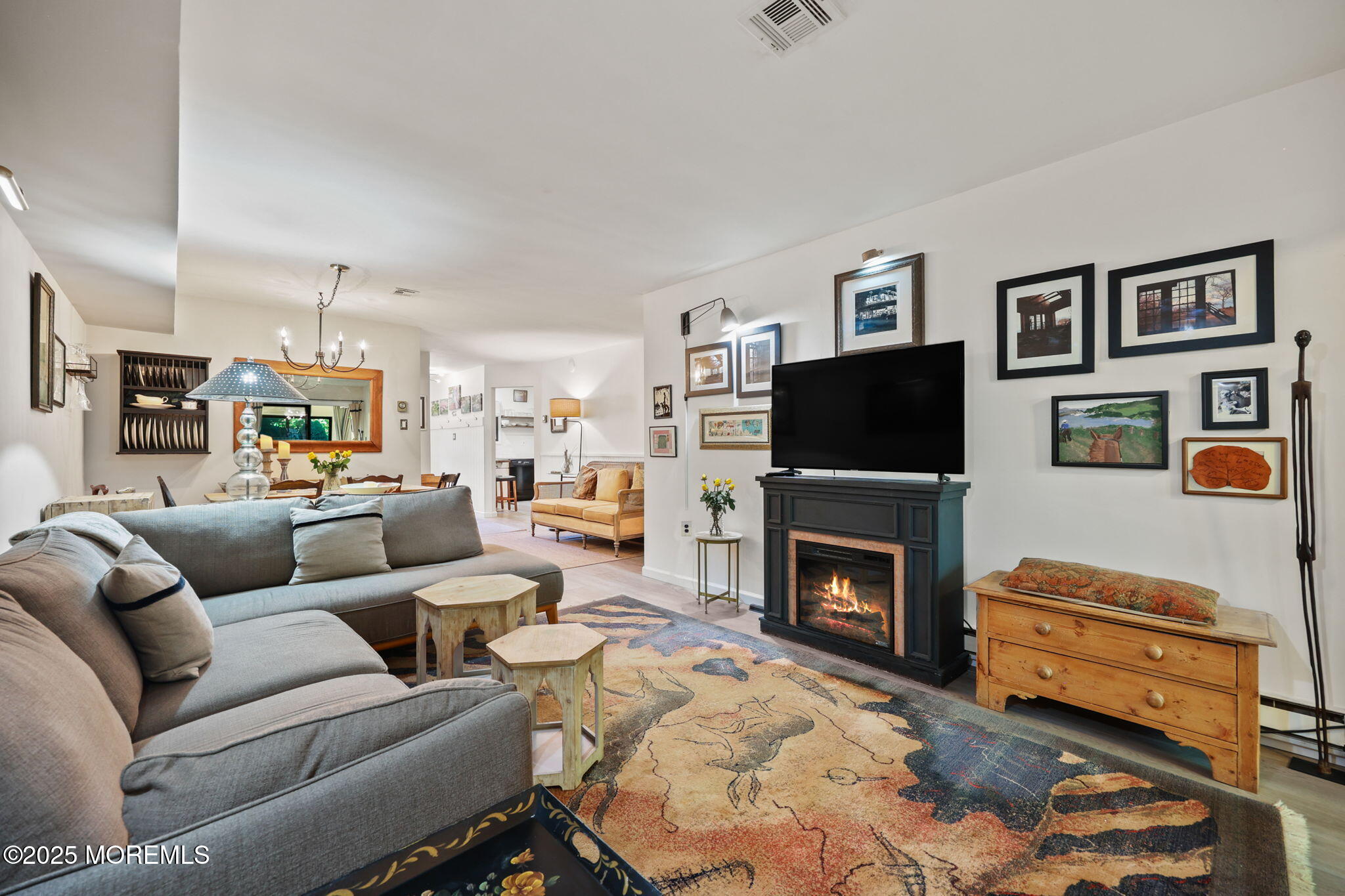 88 Friendship Court Red Bank, NJ 07701 - Photo 12 of 33 a living room with furniture a flat screen tv and a fireplace