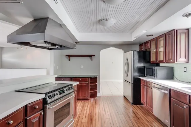 a kitchen with stainless steel appliances a sink and a stove
