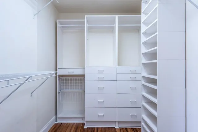 a view of a room with wooden floor and cabinet