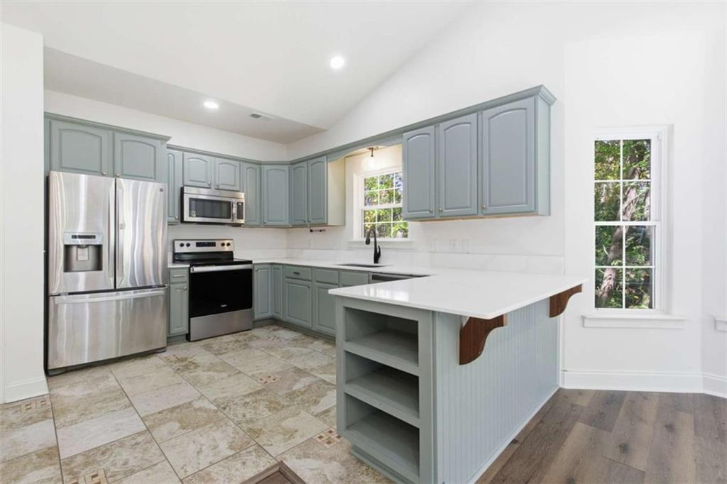 622 Spring Crest Road Cleveland, GA 30528 - Photo 11 of 48 a kitchen with kitchen island granite countertop a stove sink and refrigerator