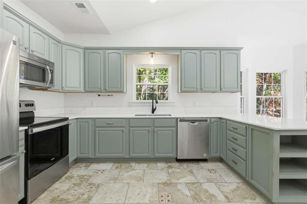 622 Spring Crest Road Cleveland, GA 30528 - Photo 14 of 48 a kitchen with a sink cabinets and stainless steel appliances