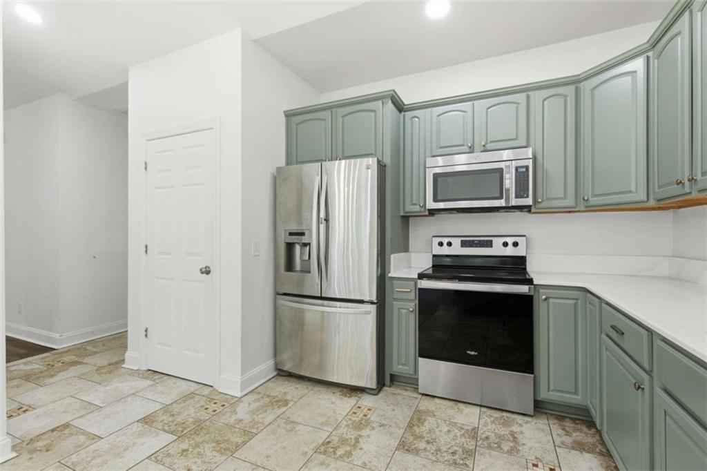 622 Spring Crest Road Cleveland, GA 30528 - Photo 17 of 48 a kitchen with stainless steel appliances granite countertop a refrigerator stove and microwave