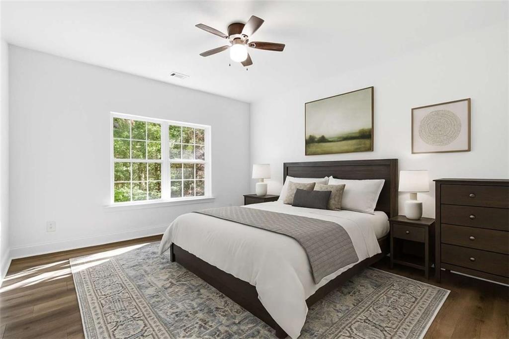 622 Spring Crest Road Cleveland, GA 30528 - Photo 18 of 48 a bedroom with a bed and a painting on the wall