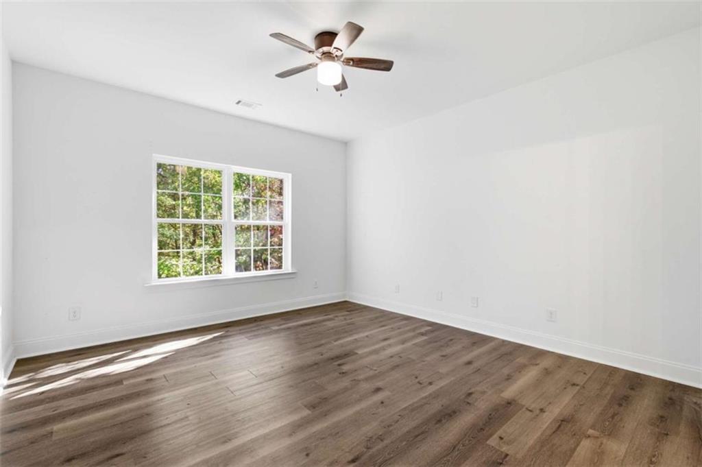 622 Spring Crest Road Cleveland, GA 30528 - Photo 19 of 48 wooden floor in an empty room with a window