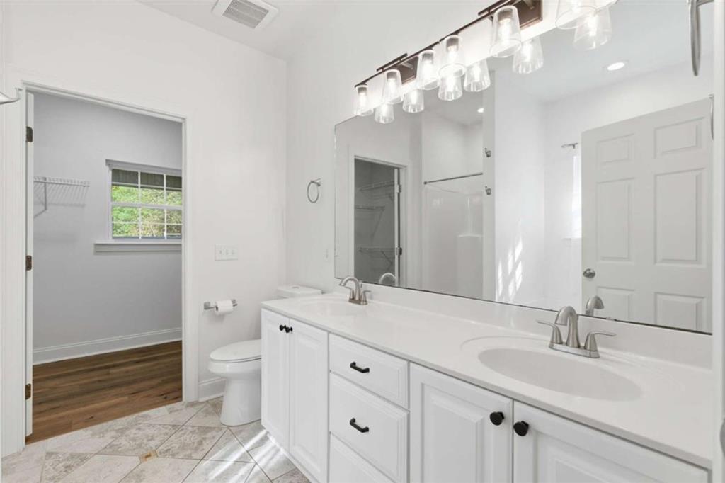 622 Spring Crest Road Cleveland, GA 30528 - Photo 21 of 48 a bathroom with a double vanity sink mirror and toilet