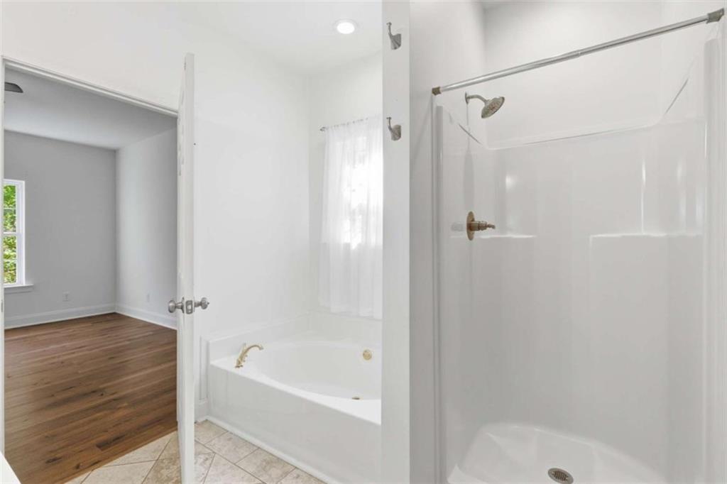 622 Spring Crest Road Cleveland, GA 30528 - Photo 22 of 48 a bathroom with a bathtub and a shower