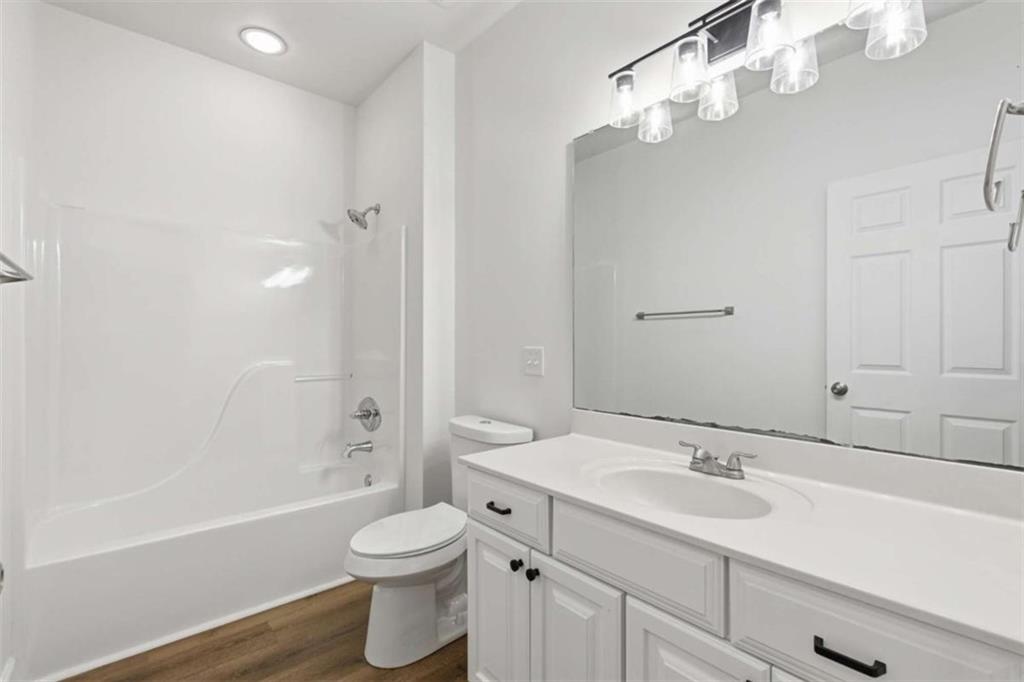 622 Spring Crest Road Cleveland, GA 30528 - Photo 34 of 48 a bathroom with a sink a toilet a mirror and shower