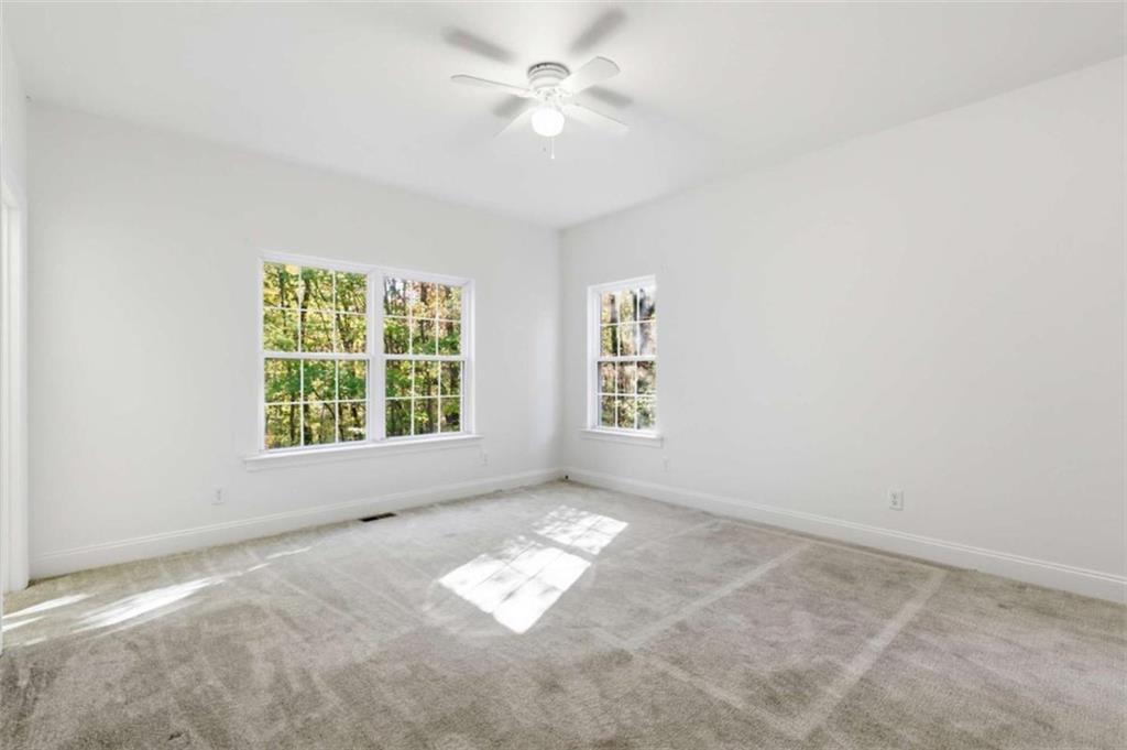 622 Spring Crest Road Cleveland, GA 30528 - Photo 35 of 48 an empty room with windows and fan