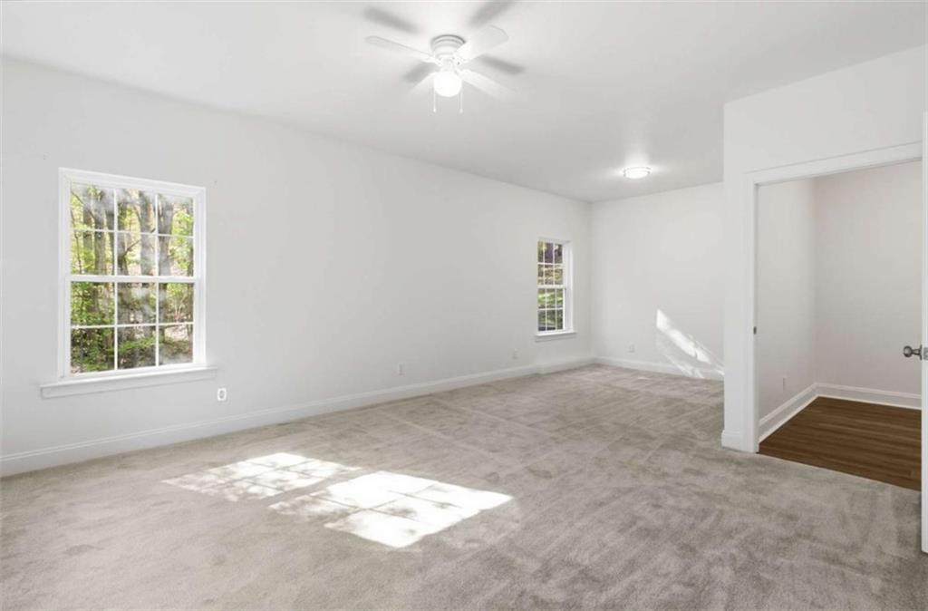 622 Spring Crest Road Cleveland, GA 30528 - Photo 36 of 48 an empty room with windows and fan