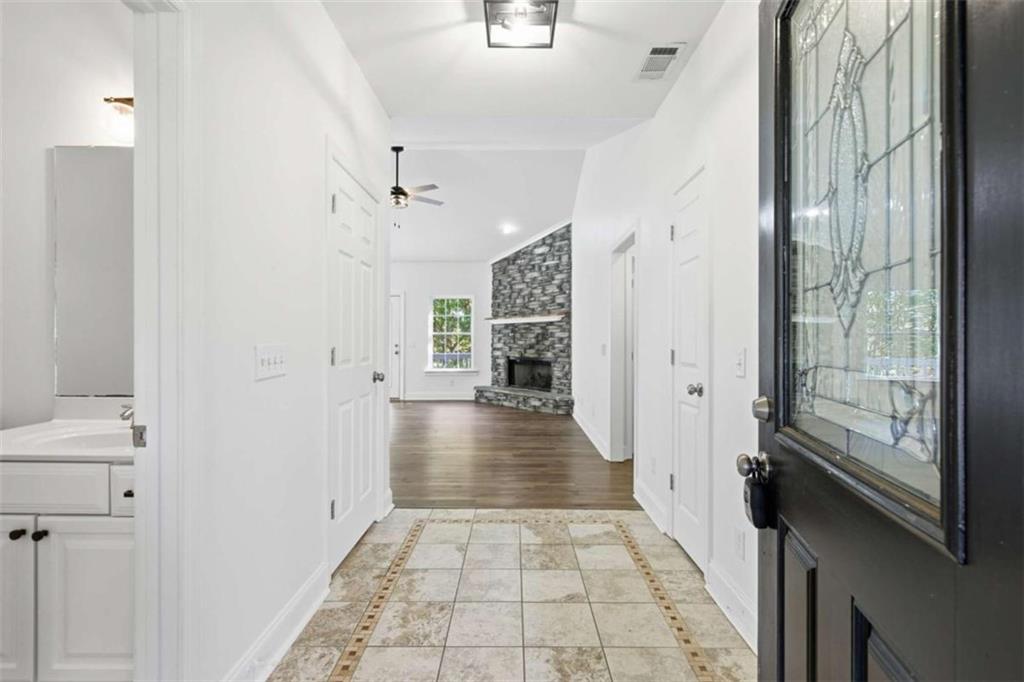 622 Spring Crest Road Cleveland, GA 30528 - Photo 4 of 48 a view of a hallway with wooden floor and a bathroom