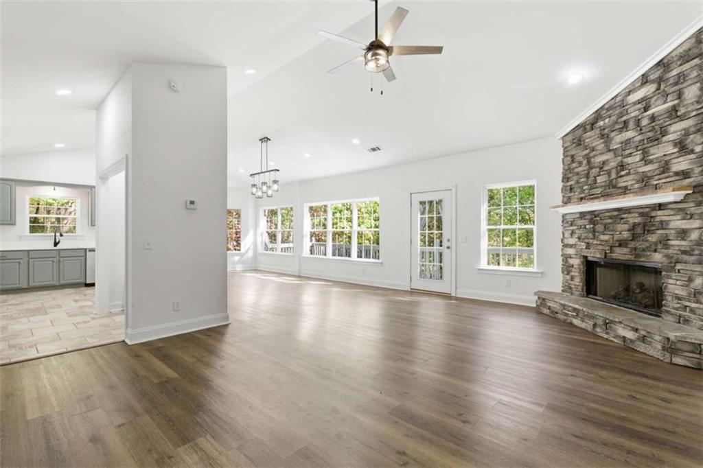 622 Spring Crest Road Cleveland, GA 30528 - Photo 6 of 48 an empty room with windows fireplace and wooden floor