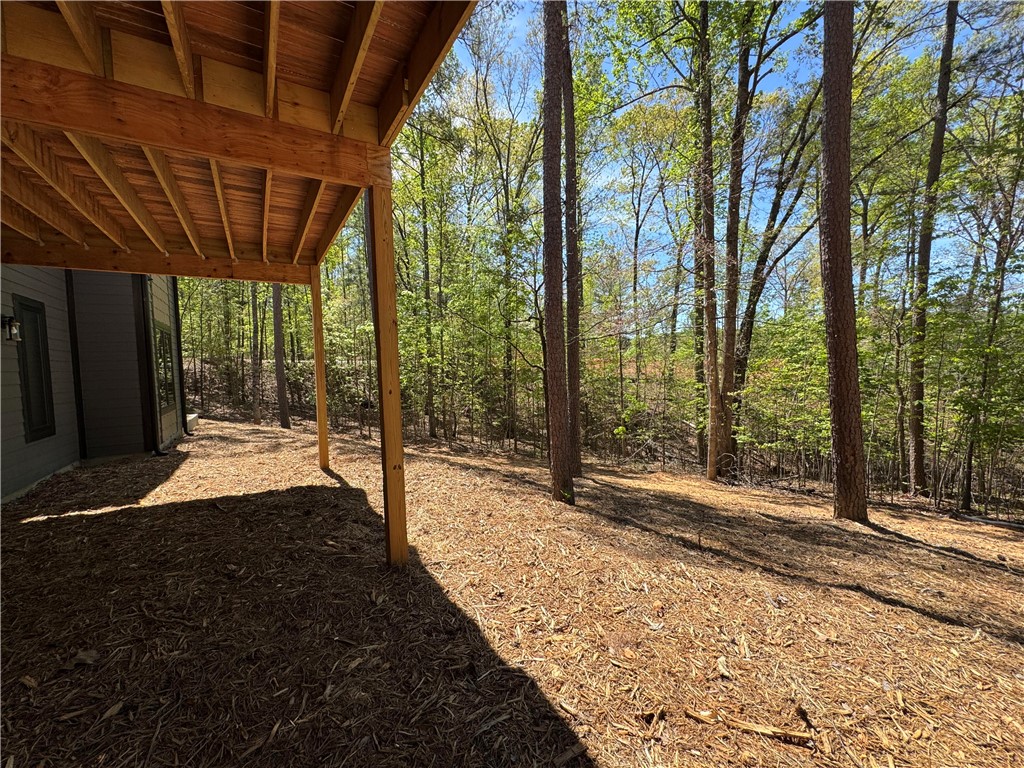940 Coachmans Trail West Union, SC 29696 - Photo 33 of 41 This tranquil outdoor space offers a covered patio area, surrounded by a lush, natural landscape.