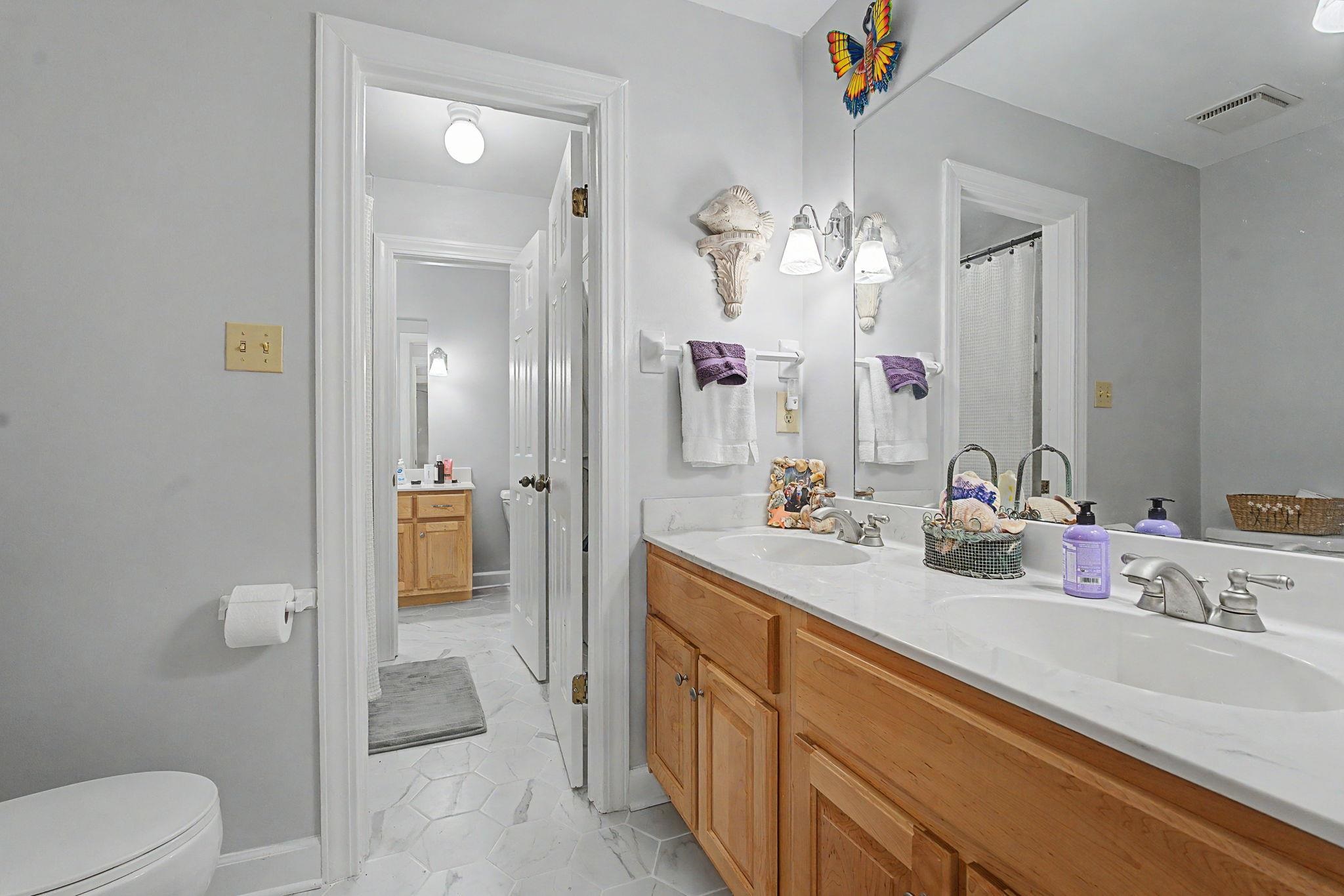 1929 Miller Farms Road Germantown, TN 38138 - Photo 29 of 40 Bathroom featuring a double vanity with light wood cabinetry, white countertops, and dual undermount sinks