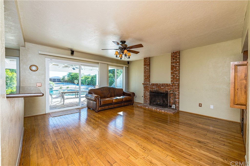 22041 Windtree Avenue Wildomar, CA 92595 - Photo 11 of 47 a living room with furniture and a fireplace