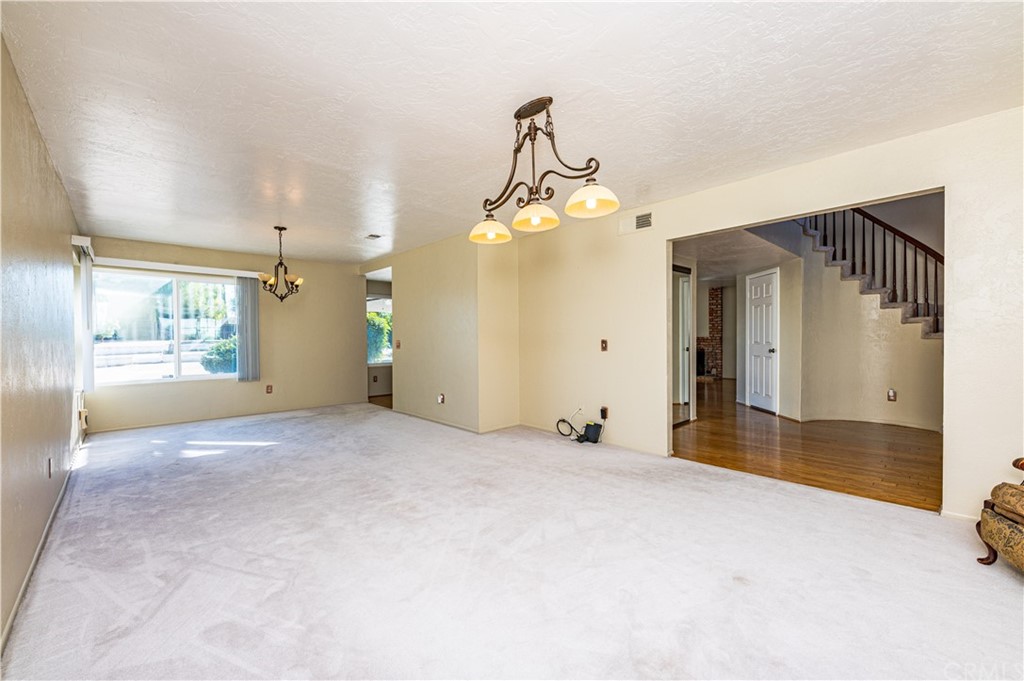 22041 Windtree Avenue Wildomar, CA 92595 - Photo 17 of 47 a view of a hallway with a chandelier