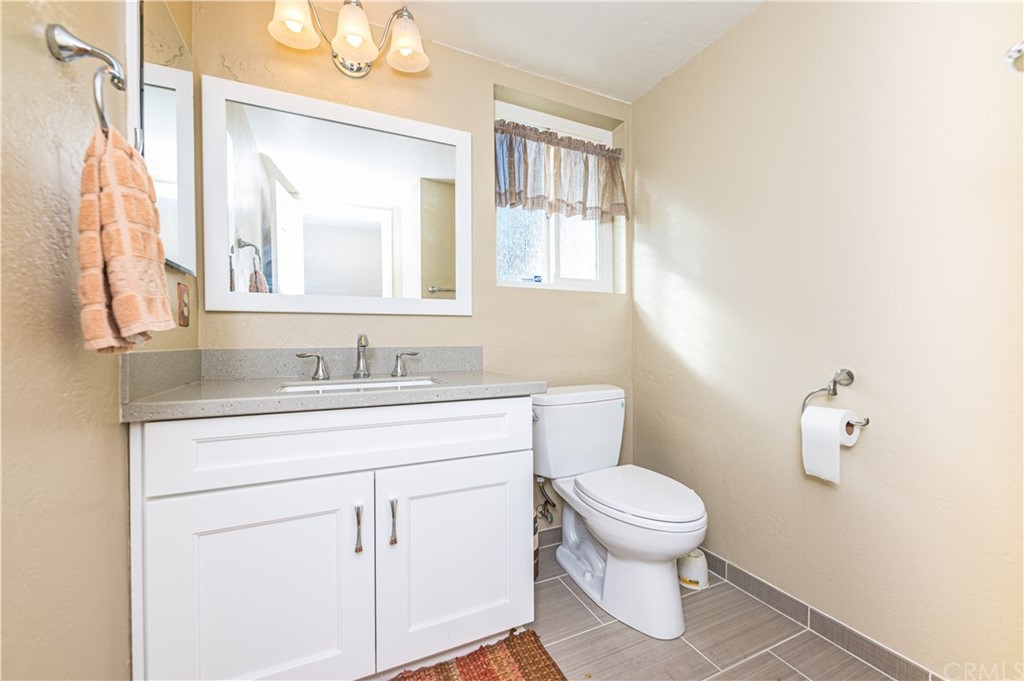 22041 Windtree Avenue Wildomar, CA 92595 - Photo 19 of 47 a bathroom with a sink a toilet and a mirror