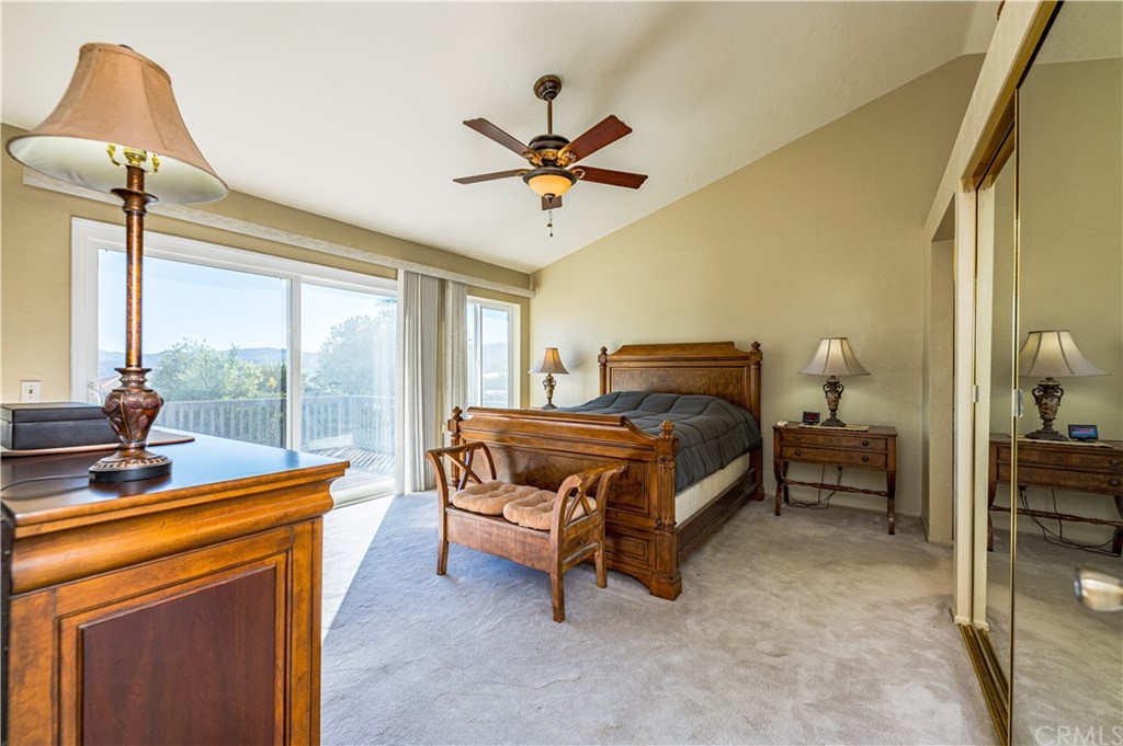 22041 Windtree Avenue Wildomar, CA 92595 - Photo 22 of 47 a bedroom with a bed and a chandelier