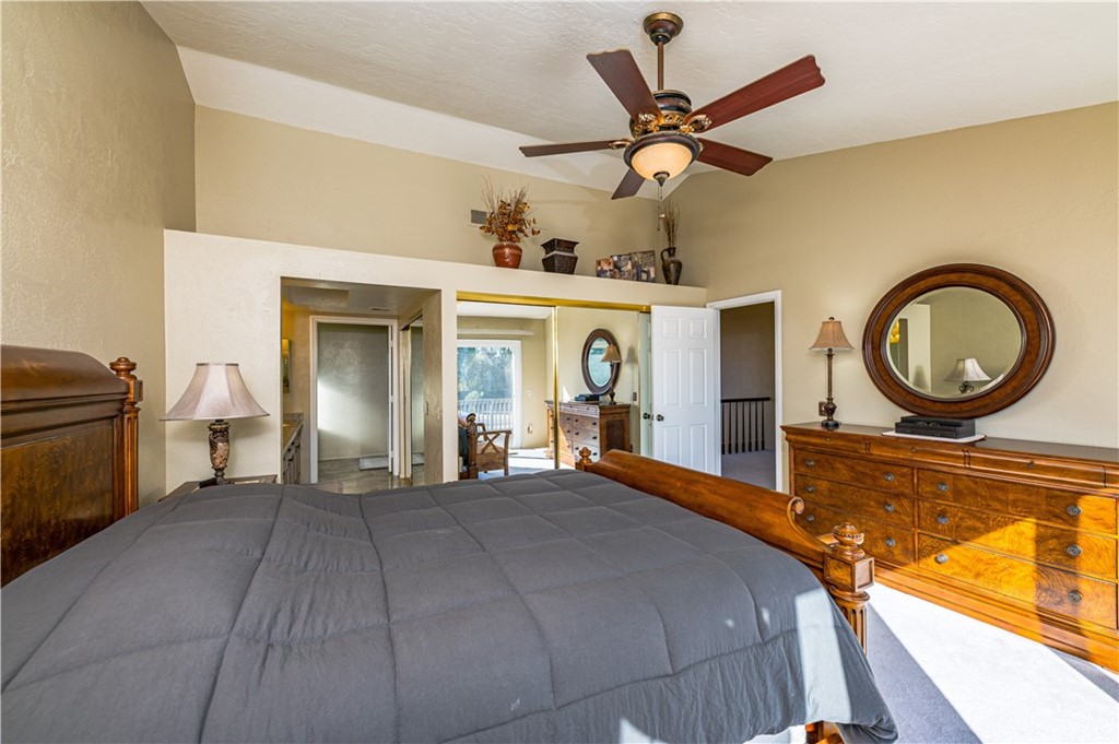 22041 Windtree Avenue Wildomar, CA 92595 - Photo 23 of 47 a bedroom with a bed and ceiling fan