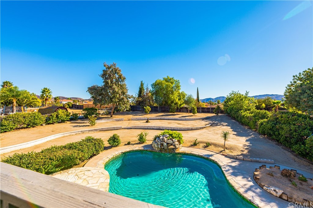 22041 Windtree Avenue Wildomar, CA 92595 - Photo 26 of 47 a swimming pool with outdoor seating and yard