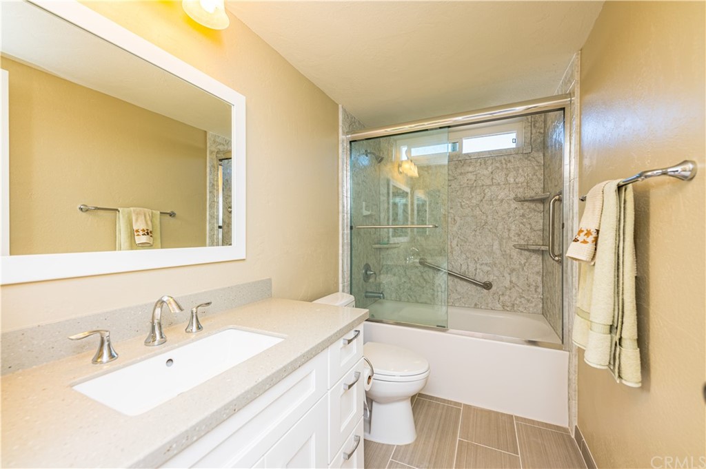 22041 Windtree Avenue Wildomar, CA 92595 - Photo 29 of 47 a bathroom with a bathtub shower sink vanity and toilet