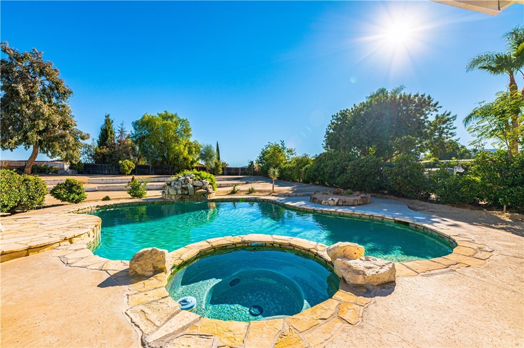 22041 Windtree Avenue Wildomar, CA 92595 - Photo 36 of 47 a view of a swimming pool with a yard