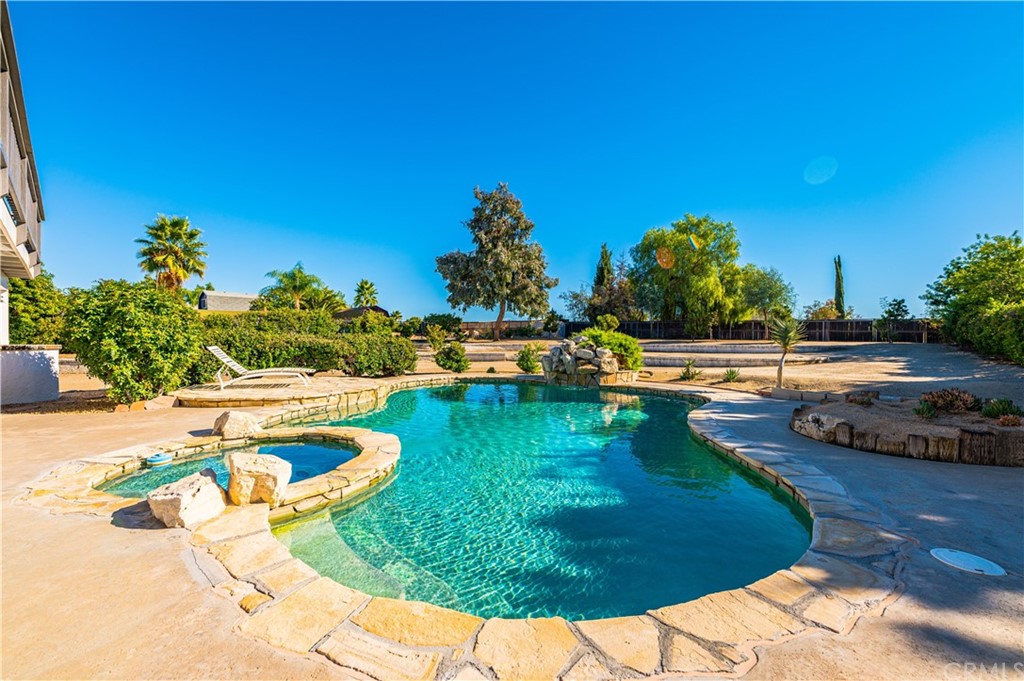 22041 Windtree Avenue Wildomar, CA 92595 - Photo 37 of 47 a view of a swimming pool with a yard