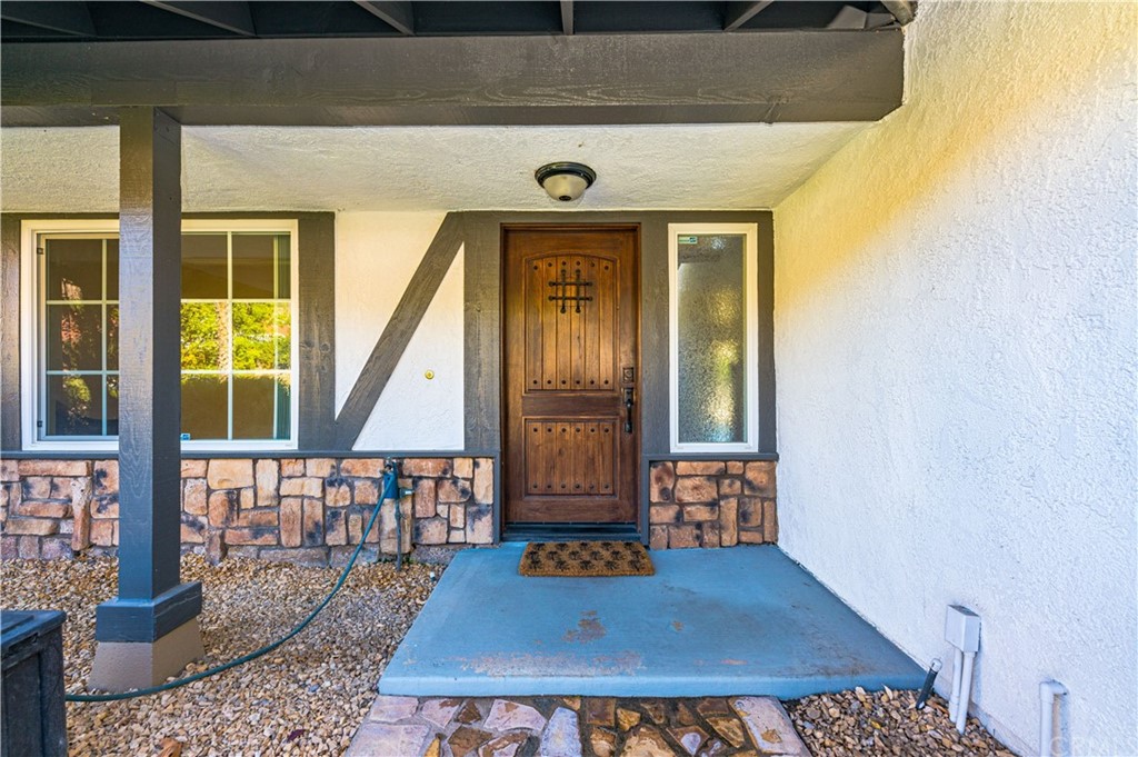 22041 Windtree Avenue Wildomar, CA 92595 - Photo 9 of 47 a front view of a house with entryway