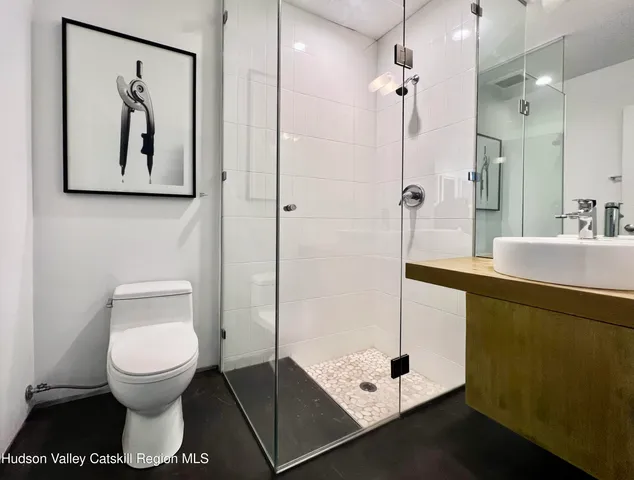 a bathroom with a toilet a sink and mirror