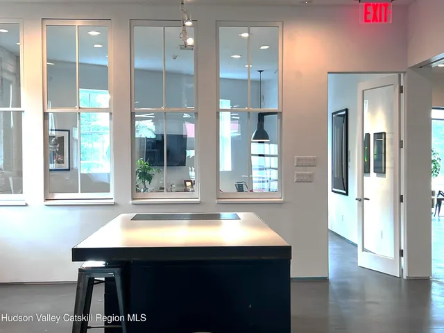 a kitchen with a sink cabinets and wooden floor